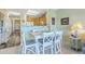 The dining area with seating for six adjoins the living room and the kitchen at 2393 Folly Rd # 1G, Folly Beach, SC 29439