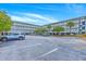 Condominium exterior showcasing multiple levels of balconies and ample parking for residents and guests at 2393 Folly Rd # 1G, Folly Beach, SC 29439