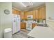 Well-equipped kitchen with white appliances and wood-toned cabinets and drawers at 2393 Folly Rd # 1G, Folly Beach, SC 29439