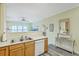 Open kitchen with stainless sink, dishwasher, and views of the living area and balcony at 2393 Folly Rd # 1G, Folly Beach, SC 29439