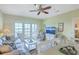 Open concept living area, with ceiling fan, furnishings, and access to the outdoor patio at 2393 Folly Rd # 1G, Folly Beach, SC 29439