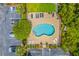 Aerial view of a community pool with ample seating, lush landscaping and convenient parking, perfect for relaxation at 2393 Folly Rd # 1G, Folly Beach, SC 29439