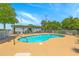 Inviting community pool area with lounge chairs and lush landscaping under a blue sky at 2393 Folly Rd # 1G, Folly Beach, SC 29439