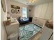 Light-filled Bedroom with pale pink walls, decorative wallpaper, and a leafy green rug at 243 Trickle Dr, Summerville, SC 29483