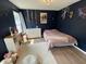 Cozy bedroom with dark blue walls, a soft rug, and natural light from the window at 243 Trickle Dr, Summerville, SC 29483