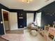 This bedroom features dark blue walls, light wood flooring, and a plush rug at 243 Trickle Dr, Summerville, SC 29483