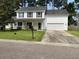 Charming two-story home with white siding, black shutters, well-maintained lawn, and attached garage at 243 Trickle Dr, Summerville, SC 29483