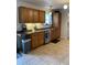 Well-equipped kitchen with wooden cabinets, tiled floors, and stainless steel appliances at 243 Trickle Dr, Summerville, SC 29483