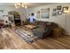 Comfortable living room with sectional sofa, wood floors, decorative rug, and ample natural light at 243 Trickle Dr, Summerville, SC 29483
