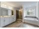 Bright bathroom features a double sink vanity, soaking tub, and a large glass-enclosed shower at 2688 Jacana Ct, Mount Pleasant, SC 29466