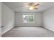 Large bedroom featuring neutral carpet, a ceiling fan, and a double window overlooking the neighborhood at 2688 Jacana Ct, Mount Pleasant, SC 29466