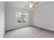 Bright bedroom with neutral carpet, ceiling fan, and a large window overlooking the backyard at 2688 Jacana Ct, Mount Pleasant, SC 29466