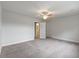 Empty bedroom with plush carpeting, a ceiling fan, and a door leading to the bathroom at 2688 Jacana Ct, Mount Pleasant, SC 29466