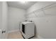 Bright laundry room features a modern washer and dryer, plus a wire storage shelf at 2688 Jacana Ct, Mount Pleasant, SC 29466