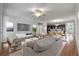 Open-concept living room featuring hardwood floors, a ceiling fan, and seamless flow to the kitchen at 2688 Jacana Ct, Mount Pleasant, SC 29466