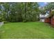 Beautiful backyard showcasing a home's lawn, greenery, and surrounding trees at 2708 Mawood Ave, North Charleston, SC 29406