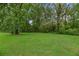 Large, well-manicured backyard with mature trees and lush green grass at 2708 Mawood Ave, North Charleston, SC 29406