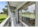 Covered balcony with golf course views provides a serene spot with chairs and a table for relaxation at 291 Sea Cloud Cir, Edisto Beach, SC 29438