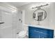 Bathroom featuring a shower, toilet, round mirror, and blue vanity with a white countertop at 291 Sea Cloud Cir, Edisto Beach, SC 29438