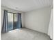 Unfurnished bedroom with sliding glass doors leading to a balcony, carpeted floors and gray walls at 291 Sea Cloud Cir, Edisto Beach, SC 29438