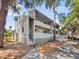 Multi-story condo building features updated exterior paint, white trim and balconies overlooking mature trees at 291 Sea Cloud Cir, Edisto Beach, SC 29438