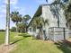 Exterior of condo building surrounded by palm trees and grass at 291 Sea Cloud Cir, Edisto Beach, SC 29438