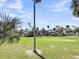 Scenic golf course view with palm trees and residential homes at 291 Sea Cloud Cir, Edisto Beach, SC 29438