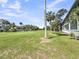 Manicured golf course with palm trees, blue sky, and residential homes at 291 Sea Cloud Cir, Edisto Beach, SC 29438