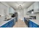 Stylish kitchen features stainless steel appliances, modern blue cabinets, and bright lighting fixtures at 291 Sea Cloud Cir, Edisto Beach, SC 29438