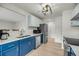 Modern kitchen boasts two-toned cabinets, stainless appliances, quartz countertops, and ample storage at 291 Sea Cloud Cir, Edisto Beach, SC 29438