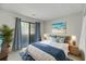 Tastefully decorated main bedroom with balcony access, blue bedding, side tables, and beachy decor at 291 Sea Cloud Cir, Edisto Beach, SC 29438