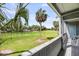 Charming patio view with a golf course, tropical trees, and blue sky at 291 Sea Cloud Cir, Edisto Beach, SC 29438