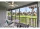 Inviting screened-in porch offers golf course views, seating, ceiling fan, and a calming space to relax at 291 Sea Cloud Cir, Edisto Beach, SC 29438