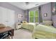 Cozy bedroom with two twin beds, a ceiling fan, and a window with natural light at 300 Bucksley Ln # 102, Charleston, SC 29492