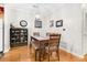 Dining room featuring hardwood floors, a wooden table set with upholstered chairs, and display cabinet at 300 Bucksley Ln # 102, Charleston, SC 29492