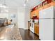 Well-equipped kitchen featuring a breakfast bar, white refrigerator, and modern appliances against a red accent wall at 300 Bucksley Ln # 102, Charleston, SC 29492