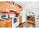 Bright kitchen with wooden cabinets, granite countertops, and stainless steel appliances at 300 Bucksley Ln # 102, Charleston, SC 29492