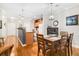 Open-concept view of the kitchen and dining area, featuring hardwood floors and granite countertops at 300 Bucksley Ln # 102, Charleston, SC 29492