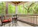 Outdoor screened porch featuring a table, chairs, and peaceful wooded views at 300 Bucksley Ln # 102, Charleston, SC 29492