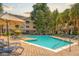Exterior view of a community swimming pool with lounge chairs and nearby condos at 300 Bucksley Ln # 102, Charleston, SC 29492