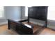 Bedroom with hardwood floors and a dark wood bed frame set against neutral walls at 301 Ridge St, Saint George, SC 29477