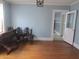 Spacious dining room featuring hardwood floors, light blue walls, and large double doors at 301 Ridge St, Saint George, SC 29477