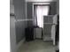 A kitchen area features a refrigerator, mini fridge, gray walls, and a decorative rack at 301 Ridge St, Saint George, SC 29477