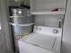 A laundry area features a hot water tank, washing machine, and utility shelf at 301 Ridge St, Saint George, SC 29477