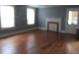 Spacious living room featuring hardwood floors and a bright fireplace, offering plenty of natural light at 301 Ridge St, Saint George, SC 29477