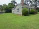 Spacious green lawn surrounding a gray home with lush trees providing shade and privacy at 301 Ridge St, Saint George, SC 29477