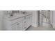 Bright bathroom features a double sink vanity, quartz countertop, white cabinets, and tile flooring at 3027 Robeson Trce, Johns Island, SC 29455