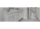 Bright bathroom features a double sink vanity, quartz countertop, white cabinets, and tile flooring at 3027 Robeson Trce, Johns Island, SC 29455