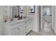 Bright bathroom features a double sink vanity, quartz countertop, white cabinets, and tile flooring at 3027 Robeson Trce, Johns Island, SC 29455