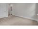 Empty bedroom with a neutral carpet, white door, and trim, creating a bright and airy atmosphere at 3027 Robeson Trce, Johns Island, SC 29455